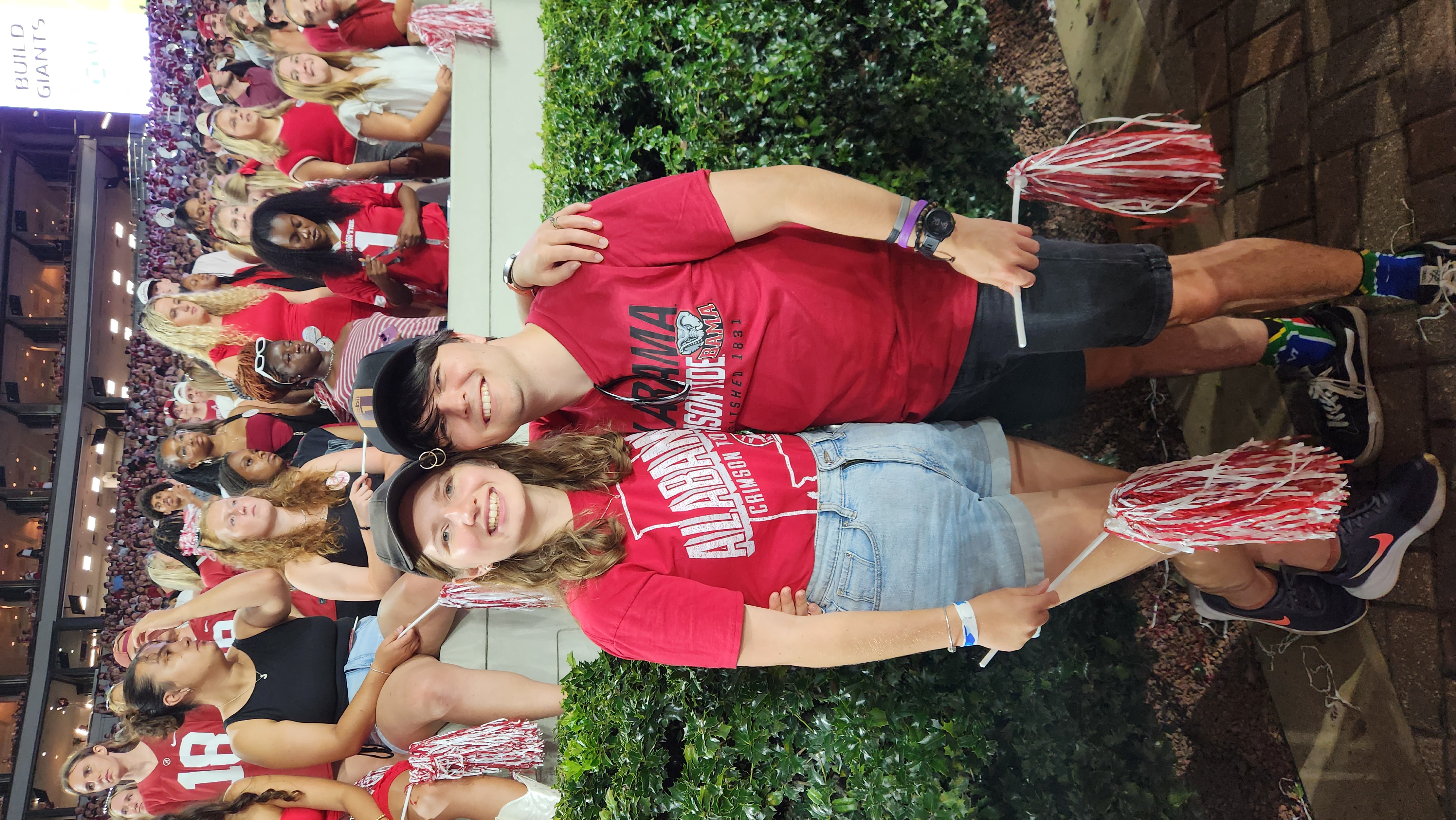 Jessica and FC in the stands at their first American football game in Tuscaloosa.